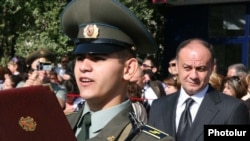 Armenia -- Defense Minister Seyran Ohanian (R) looks on as a military academy graduate takes an oath of allegience to the armed forces.
