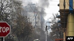 Smoke rises from the building of a Kabul hotel, which was attacked on December 12.