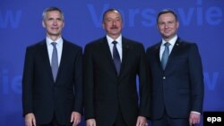 Poland -- Polish President Andrzej Duda (R) and NATO Secretary General Jens Stoltenberg (L) welcome Azerbaijan's President Ilham Aliyev (C) at the opening of the NATO Summit at the National Stadium in Warsaw, Poland, 08 July 2016.
