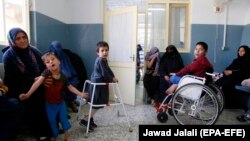 Afghan women and children wait to receive medical service at the pediatric center of the International Committee of the Red Cross (ICRC) in Kabul.