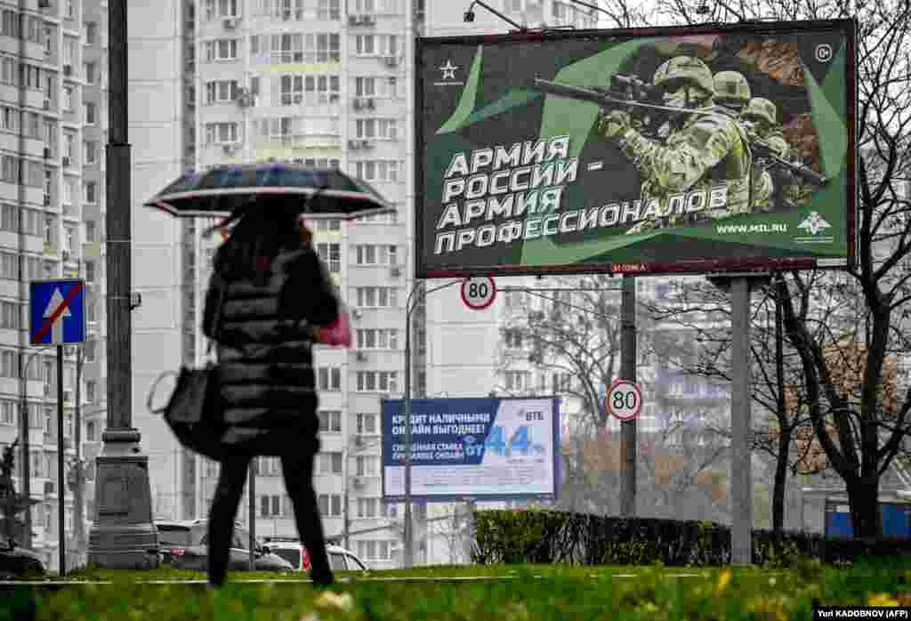 Pe o stradă din Moscova, un afiș cu soldați ruși pe care scrie &bdquo;Armata Rusiei - Armata profesioniștilor&rdquo;.