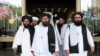 Members of a Taliban delegation, led by chief negotiator Mullah Abdul Ghani Baradar (Center, front), leave after peace talks with Afghan senior politicians in Moscow on May 30.