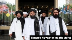 Members of a Taliban delegation, led by chief negotiator Mullah Abdul Ghani Baradar (Center, front), leave after peace talks with Afghan senior politicians in Moscow on May 30.