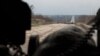 Погляд з блокпосту на дорогу, яка веде до розв&rsquo;язки на Ясинувату (контрольовану проросійськими бойовиками). Будівлі і труба ліворуч &ndash; це Донецька фільтраційна станція