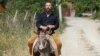 Russian businessman German Sterligov rides a donkey in Nagorno-Karabakh, 7Jul2015.
