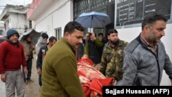 An injured man is carried on a stretcher at a hospital in the Indian-administered Kashmir's frontier town of Mendhar on March 2.