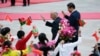 Afghanistan's President Ashraf Ghani Ahmadzai and China's President Xi Jinping (R) wave to students during a welcoming ceremony outside in Beijing, October 2014.