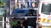 Police sit in front of a crashed vehicle after Saeed Noori, the driver, was arrested after plowing into pedestrians at a crowded intersection in Melbourne in December 2017.
