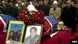 People pay their last respects in February 2002 to the three Bytyqi brothers -- Ylli, Agron, and Mehmet -- who were found the previous June in a grave with more than 70 other Kosovo Albanians in Serbia's Petrovo Selo.