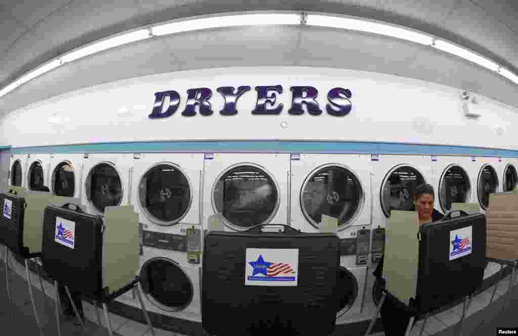 A voter casts her ballot inside a laundromat in Chicago, Illinois.&nbsp;