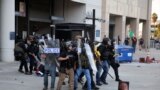 Протестующий держит мексиканский флаг во время противостояния между полицией и протестующими после многочисленных задержаний сотрудниками Иммиграционной и таможенной службы (ICE) в городе Парамаунт округа Лос-Анджелес, Калифорния, США, 7 июня 2025 года. REUTERS/Daniel Cole