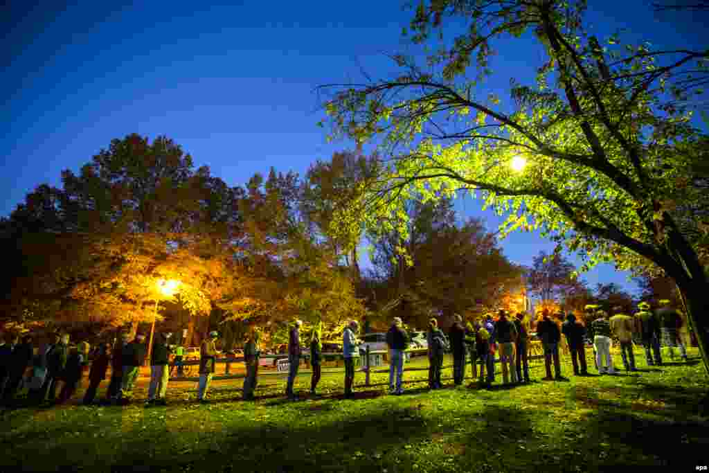 Virginia residents wait in line before the polls open at a historic property called the &#39;&#39;Hunter House&#39;&#39; in Vienna, Virginia.