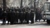 Сотрудники полиции наблюдают за участниками "митинга несогласных". Алматы, 25 февраля 2012 года.
