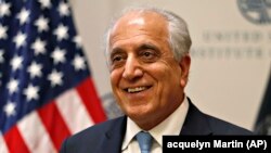 Special Representative for Afghanistan Reconciliation Zalmay Khalilzad approaches the microphone to speak on the prospects for peace at the U.S. Institute of Peace, in Washington on February 8.