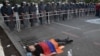 Armenia - A protester lies on the ground near riot police deployed on Marshal Bagramian Avenue, Yerevan, 26Jun2015.