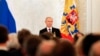 Russian President Vladimir Putin on March 18, 2014, addresses the Federal Assembly, including State Duma deputies, members of the Federation Council, regional governors, and civil society representatives on the annexation of Ukraine's Crimea region.