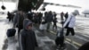 Russia -- Russian citizens, who were evacuated from Libya, leave a plane owned by the Emergency Situations Ministry as they walk along a landing runway at Domodedovo airport outside Moscow, 23feb2011