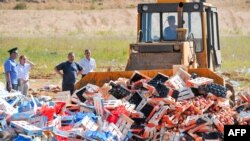 A worker uses a bulldozer to crush crates of banned peaches outside the city of Novozybkov, about 600 kilometers from Moscow, on August 7.