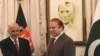 Afghan President Ashraf Ghani (L) and Pakistani Prime Minister Nawaz Sharif shake in Islamabad, November 15, 2014.
