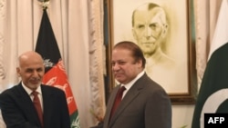 Afghan President Ashraf Ghani (L) and Pakistani Prime Minister Nawaz Sharif shake in Islamabad, November 15, 2014.