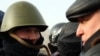 Лидер незарегистрированной партии "Алга" Владимир Козлов разговаривает с полицейским на центральной площади города Актау. 21 декабря 2011 года. Спустя несколько месяцев Козлов будет привлечен к суду за разжигание социальной розни и приговорен к семи с половиной годам тюрьмы. 