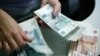 The announcement of new sanctions against Russia sparked a further downturn for the ruble, which has lost 13 percent of its value against the dollar this year.