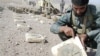 An Afghan policeman points to a mark on a landmine found in Ghurian district in Herat Province (file photo)