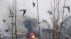 Flames and smoke billow from a residential building where militants are suspected to have taken refuge during a gun battle in Pulwama, south of Srinagar in Indian-controlled Kashmir on February 18.