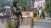 An Indian paramilitary trooper stands guard along a street in Srinagar on April 30, 2025.