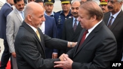 Pakistan Prime Minister Nawaz Sharif, right, greets Afghan President Ashraf Ghani upon his arrival at the military Nur Khan airbase in Rawalpindi on December 9.