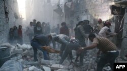 Syria - Syrian Civil Defence workers and pedestrians clear debris after an alleged air strike by Syrian government forces in the Bab al-Nairab neighboured the northern Syrian city of Aleppo on November 12, 2014