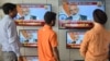 Indian men watch a live broadcast of Indian Prime Minister Narendra Modi on televisions displayed in an electronic store, in Amritsar on March 27.