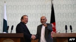 Pakistani Prime Minister Nawaz Sharif (L) shaking hands with Afghan President Ashraf Ghani in Kabul on May 12.