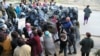 Полицейские силой прорвали слабый кордон женщин, преградивших им путь. Микрорайон Шанырак, Алматы, 14 июля 2006 года.