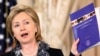 U.S. -- U.S. Secretary of State Hillary Rodham Clinton holds up a copy of the 2010 Trafficking in Persons Report during an event at the State Department in Washington, DC. , 14Jun2010